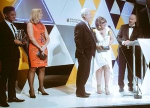 Alf and Nadia Taylor receive the award on behalf of tna.